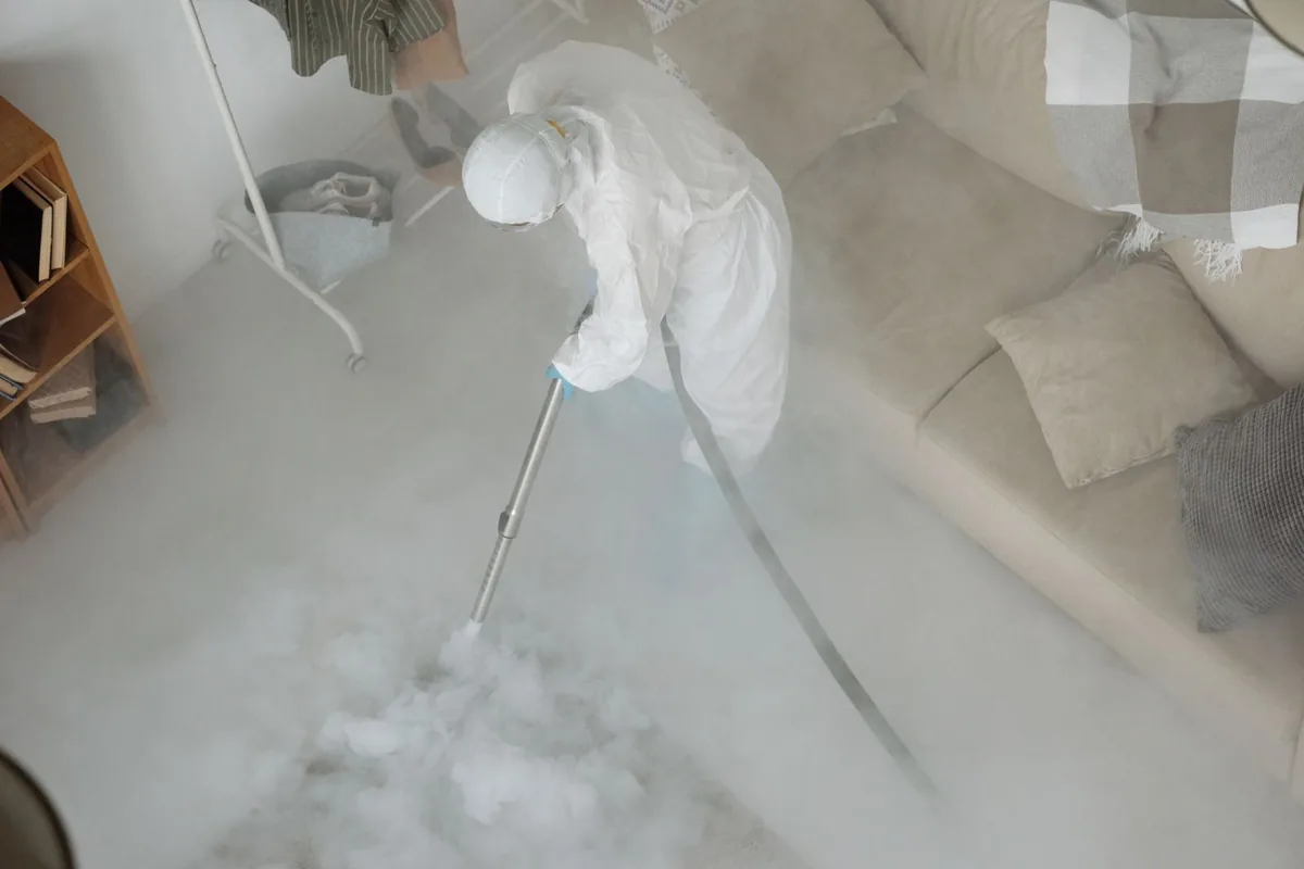 Biohazard cleanup technician in protective equipment, Fullerton, PA